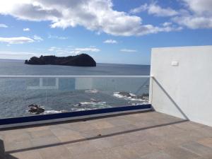 a balcony with a view of the ocean at Blue House in Vila Franca do Campo