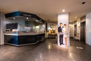 a man and a woman standing in front of a store at Hotel Liberte Asahikawa in Asahikawa