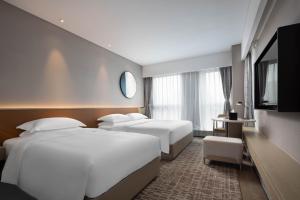 เตียงในห้องที่ Leeden Hotel Hangzhou