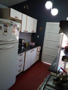 a kitchen with white cabinets and a white refrigerator at Confort y tranquilidad al 100% in Malargüe