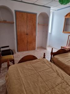 a bedroom with two beds and a closet and a cabinet at CASA en el CENTRO DE RONDA in Ronda