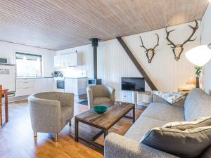 a living room with a couch and chairs and a table at Apartment Blåvand X in Blåvand