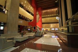 a lobby of a building with couches and a red sign at Sevilla Palace in Mexico City