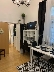 a dining room and living room with a table and chairs at Apartment Capital in Maribor