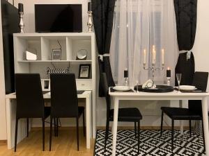 a dining room with a white table and chairs at Apartment Capital in Maribor