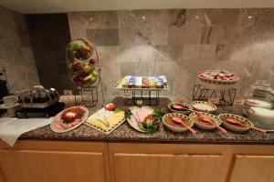 a kitchen counter filled with lots of different types of food at Sevilla Palace in Mexico City