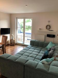 a living room with a green couch and a table at Ferienwohnung M30 in Graal-Müritz