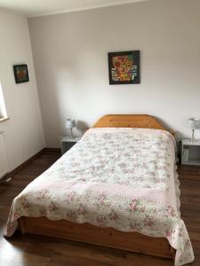 a bedroom with a bed with a blanket on it at Ferienwohnung M30 in Graal-Müritz