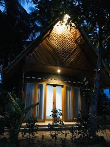 a house with a light on the roof at night at Saung Rancage Batukaras in Pangandaran