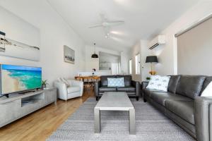a living room with a couch and a table at Lazy Days 1 in Noosaville