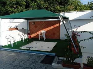 a gazebo with two chairs and a table at Casa Boutique HNP in Barrancabermeja