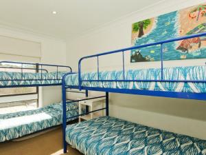 A bunk bed or bunk beds in a room at Casa Callala on King George - well appointed home