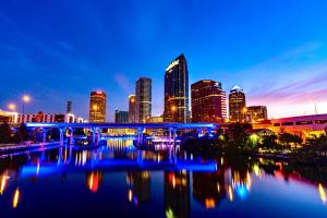 a city skyline with a blue bridge over a river at LUXURIOUS COZY STUDIO. in Tampa
