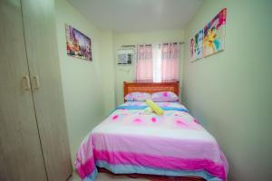 a bedroom with a bed with a teddy bear on it at Mailz Haven #5 New Homey Apartment 750m near SM in Davao City