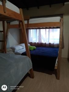 two bunk beds in a room with a window at Hostal Naty Luna in Jardin