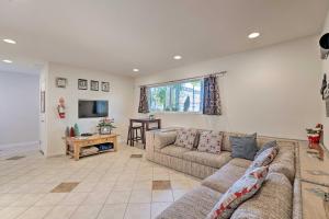 a living room with a couch and a tv at Vegas Oasis Home with Pool and Spa 7 Miles to Strip in Las Vegas