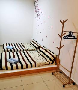 a bed with a wooden frame in a room at Holiday Homestay Seremban in Seremban +12 photos