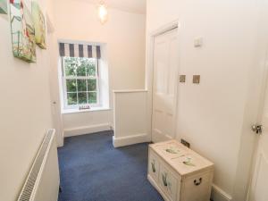 a room with a white room with a drawer and a window at Ty'r Ysgol in Morfa Bychan +25 photos