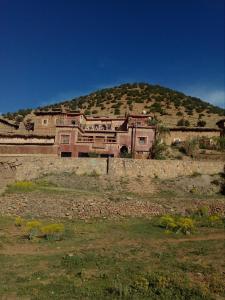 a large house on top of a hill at Gte Tawada - Haut-atlas - Room for 2 people in Ikhf nʼIghir