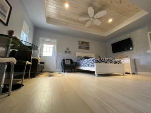 a bedroom with a bed and a ceiling fan at Nicoles Nest Brand New Exquisite Studio Hideaway in Freeport