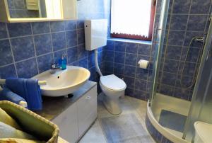 a bathroom with a sink and a toilet and a shower at Apartment by the sea and with beautiful view, 2 bedrooms, 4 persons in Kali