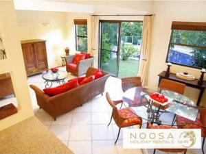 a living room with a couch and a table at Little Cove Townhouse 3 Pandanus Street 14 in Noosa Heads