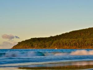 a wave in the water on a beach at Little Cove Townhouse 3 Pandanus Street 14 in Noosa Heads