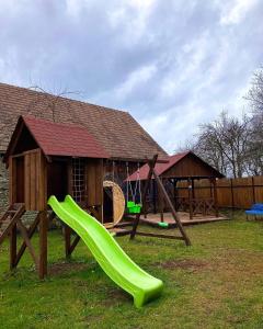 a playground with a slide and a gazebo at Chalupa Spoko Liptov in Trstené