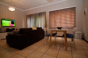 a living room with a couch and a table at The Gatehouse in Alberton