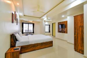 a bedroom with a large bed in a room at FabHotel White House in Pune
