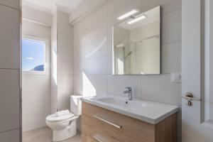 a white bathroom with a sink and a toilet at Glorieta in Calpe +18 photos