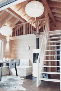 a living room with a staircase in a house at Lieblingsort - Cosy Black Forest Chalets in Neuenweg