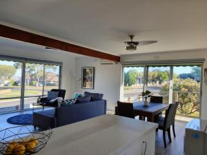 a living room with a blue couch and a table at Homely Getaway in Bell Post Hill in Norlane