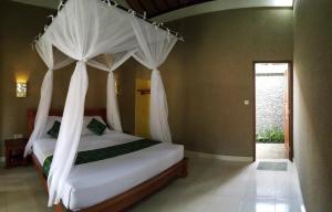Letto o letti in una camera di Mango Tree Inn