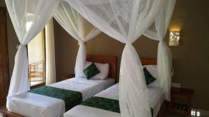 Letto o letti in una camera di Mango Tree Inn