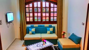 a living room with a couch and a window at Tasneem Palace in Luxor