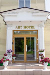 an entrance to an art hotel with two vases at ART Hotel in Kirov