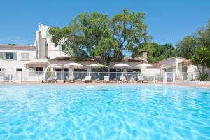 a large swimming pool in front of a building at Domaine De Caranella in Porto-Vecchio