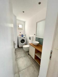 a bathroom with a sink and a washing machine at MaVi House Old Town in Malia