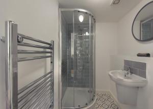 a bathroom with a shower and a toilet and a sink at Donington Cottage Apt 6 in Castle Donington