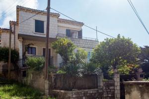 a house with a fence in front of it at Holiday Home Patricija in Dubrovnik