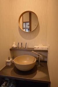 a bathroom with a bowl sink and a mirror at Daigo - Vacation STAY 07995v in Kanayama