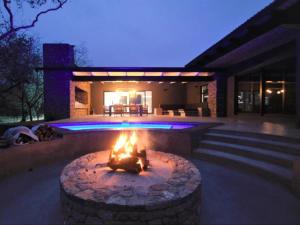 a fire pit in front of a house at night at Kruger Nights in Marloth Park