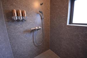 a shower in a bathroom with a shower head at Daigo - Vacation STAY 07998v in Kanayama