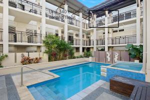 a swimming pool in front of a building at Spacious 3 bedroom apartment opposite surf club in Kingscliff