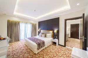 a hotel room with a bed and a mirror at Radisson Hotel Muscat Panorama in Muscat