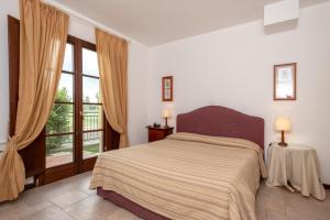 A bed or beds in a room at Poggio all'Agnello Sport & Family Holidays