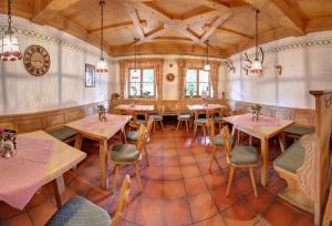 a restaurant with tables and chairs in a room at Gasthof-Metzgerei Hirschbichler - Chiemgau Karte in Inzell