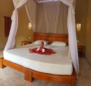 Letto o letti in una camera di Mango Tree Inn
