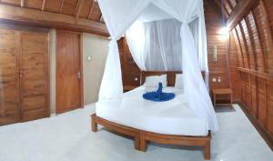 Letto o letti in una camera di Mango Tree Inn